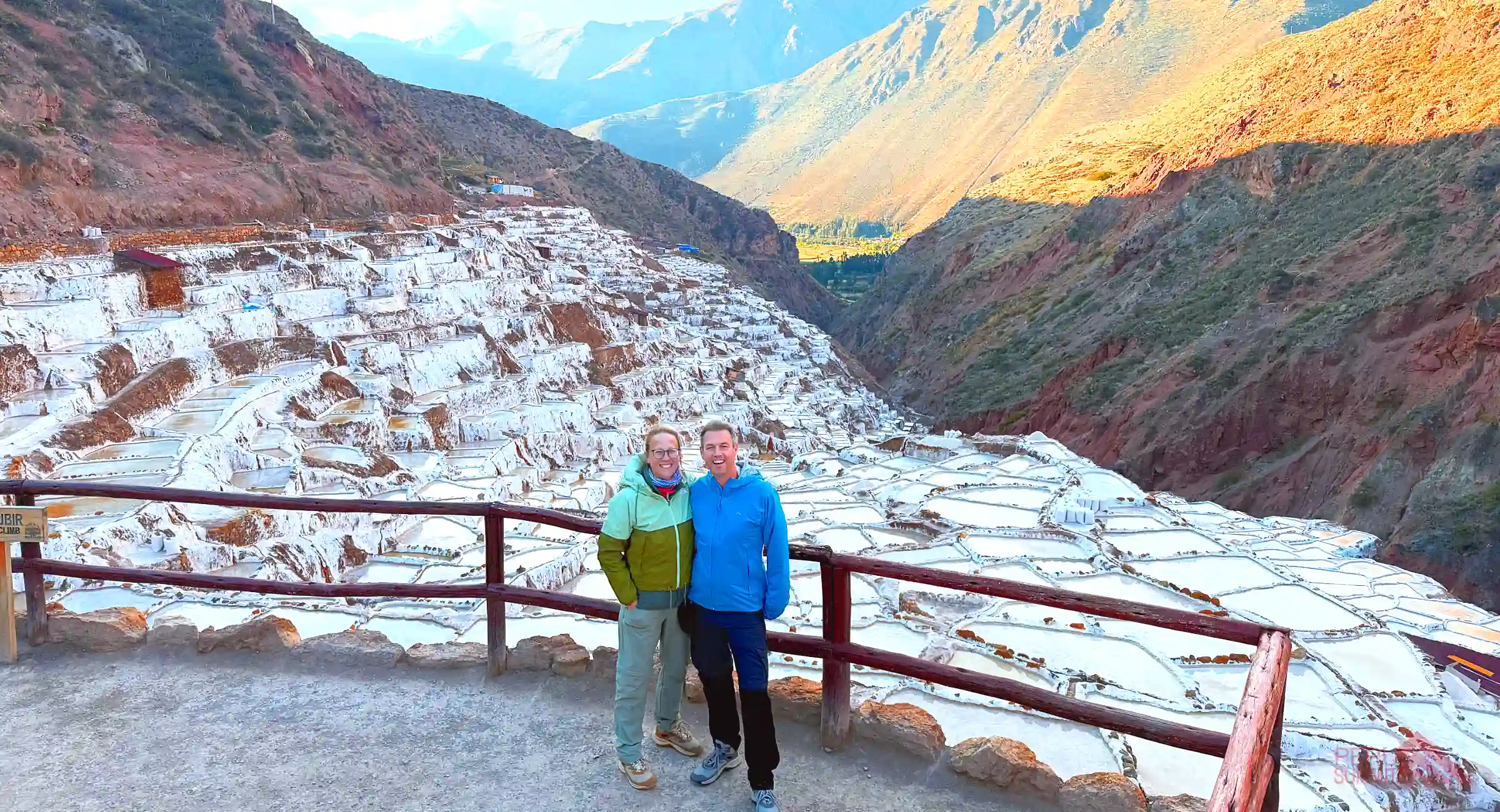 Sacred Valley Tour from Ollantaytambo to Cusco, clients in Maras Salt Mines during sunset.